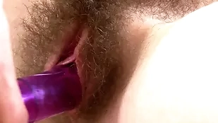 A young, slender white girl with an unshaven pussy gets up close and personal in this hardcore solo video.