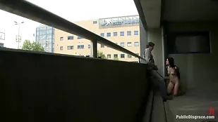 Lucy Bell engages in intense BDSM with Steve Holmes in a parking garage